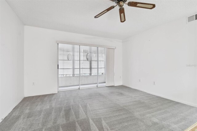 unfurnished room with light carpet, ceiling fan, and a textured ceiling