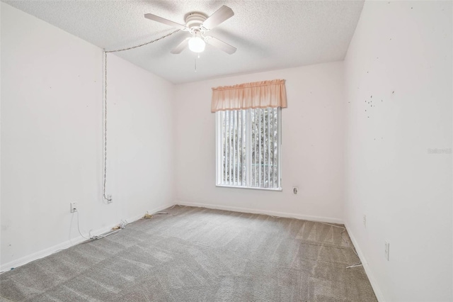 spare room with ceiling fan, carpet floors, and a textured ceiling