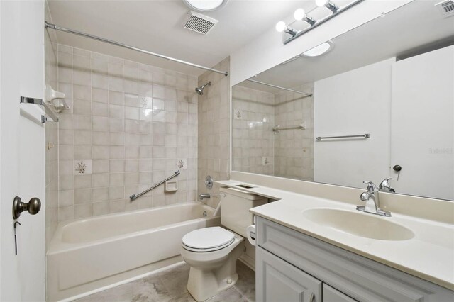 full bathroom featuring tile patterned flooring, vanity, toilet, and tiled shower / bath