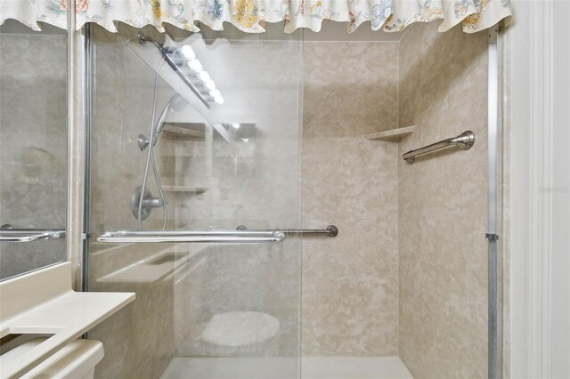 bathroom featuring a shower with door