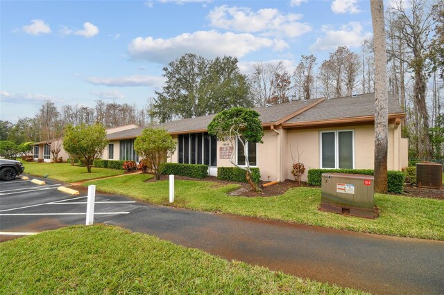 ranch-style home with a front lawn