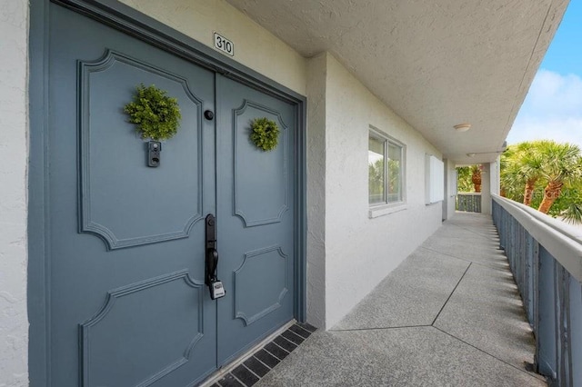 view of exterior entry with a porch