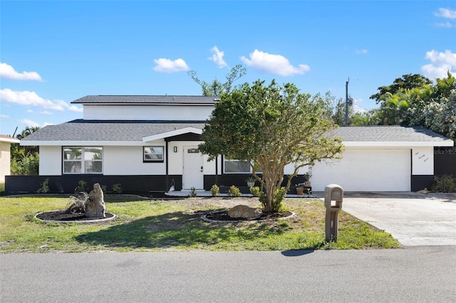 ranch-style home with a garage and a front lawn