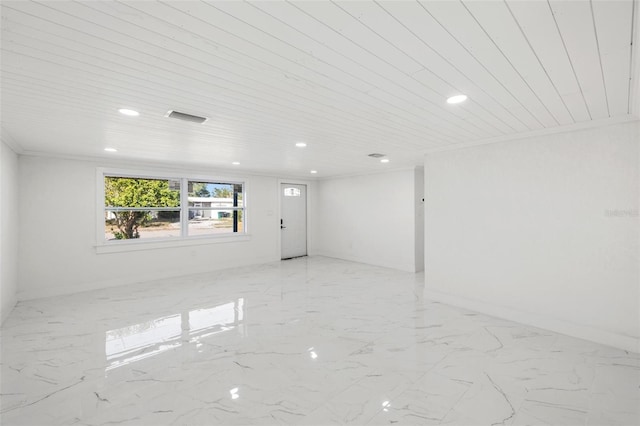 empty room with wood ceiling and crown molding