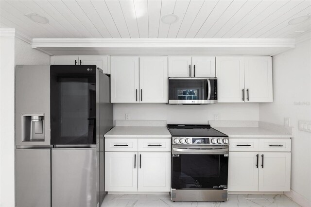 kitchen featuring white cabinets, stainless steel appliances, and crown molding