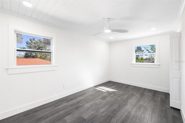 empty room featuring dark hardwood / wood-style floors, ceiling fan, and ornamental molding