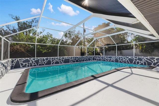 view of pool with a patio area and a lanai