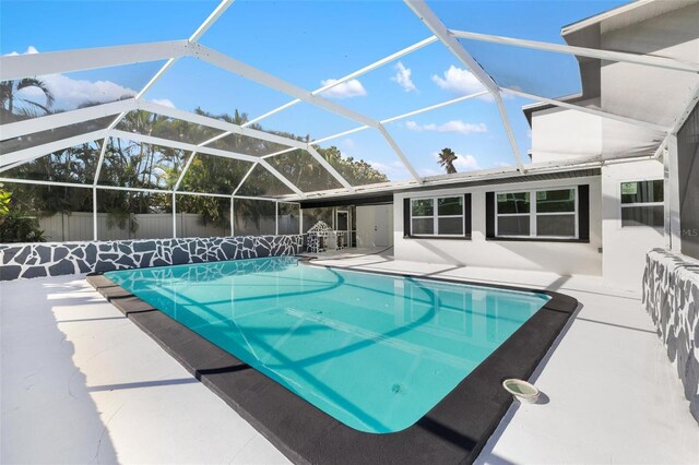 view of swimming pool with a lanai and a patio