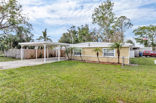 view of front of property with a carport and a front lawn