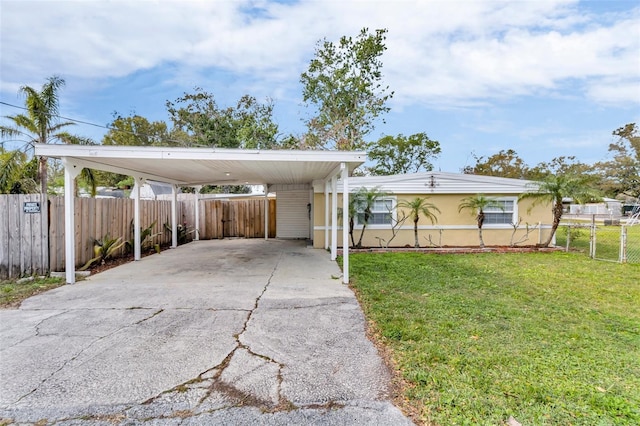 view of front facade with a carport and a front lawn