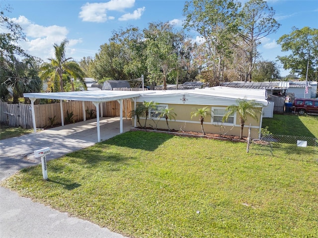 view of front of property with a front yard and a carport