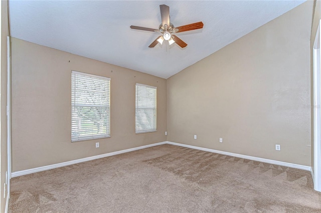 carpeted empty room with ceiling fan and vaulted ceiling