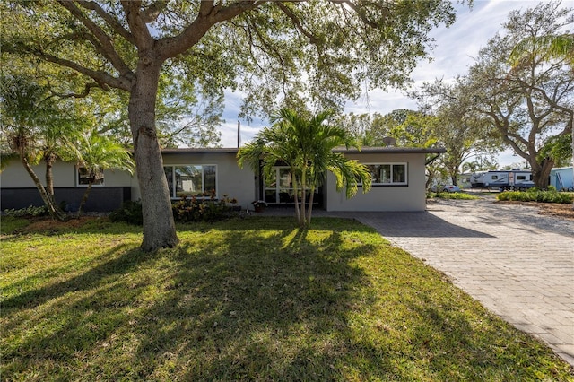 ranch-style home featuring a front yard