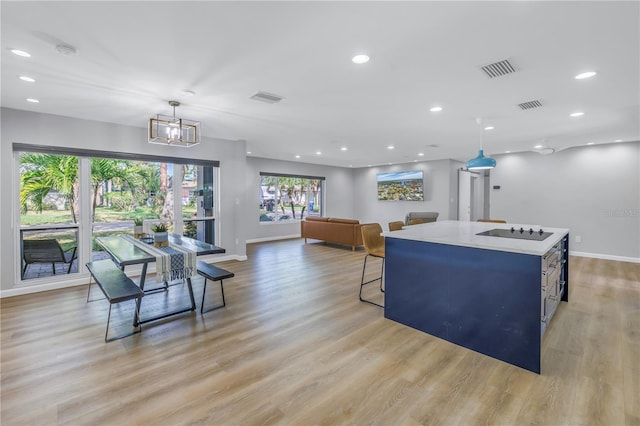 living room featuring an inviting chandelier and light hardwood / wood-style flooring