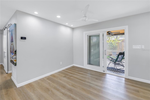 spare room with light hardwood / wood-style flooring and ceiling fan