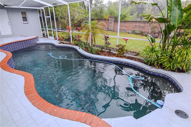 view of swimming pool with a lanai