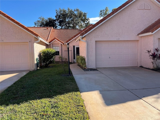 single story home featuring a front yard and a garage