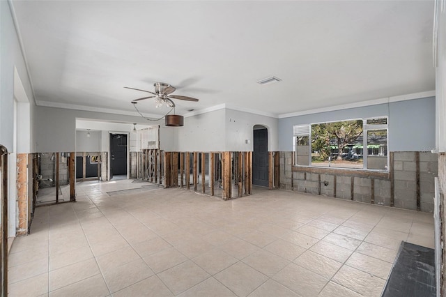 spare room with ceiling fan, light tile patterned floors, and ornamental molding