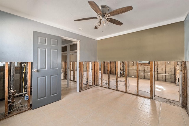 interior space with ceiling fan