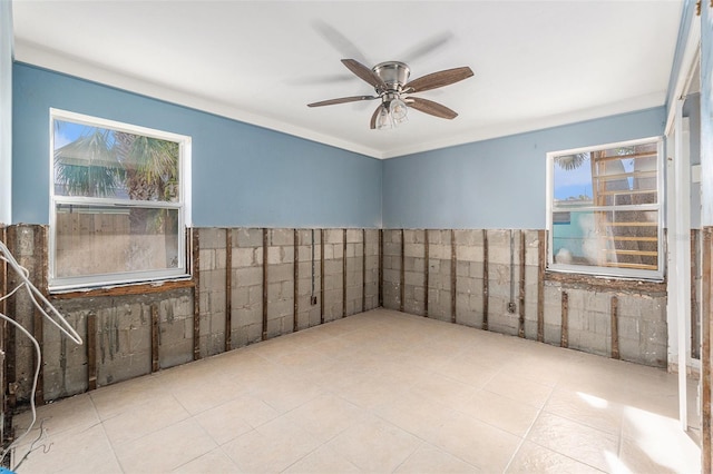 spare room with ceiling fan and ornamental molding