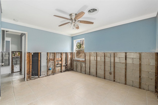 unfurnished room featuring ceiling fan and ornamental molding