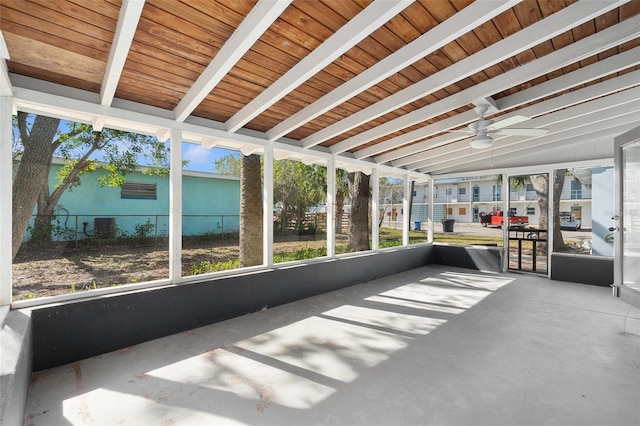 unfurnished sunroom with vaulted ceiling with beams and wood ceiling