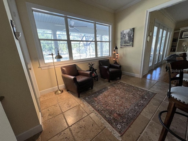 sitting room with ceiling fan and crown molding