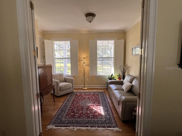 living area featuring a wealth of natural light, dark wood-type flooring, and ornamental molding