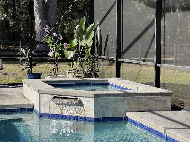 view of swimming pool with an in ground hot tub