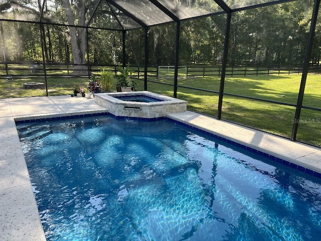 view of swimming pool featuring a lanai, a yard, and an in ground hot tub