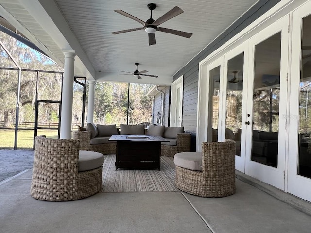 view of patio / terrace with an outdoor living space, ceiling fan, and french doors