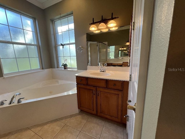 bathroom with tile patterned floors, vanity, and separate shower and tub