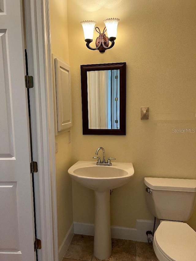 bathroom featuring tile patterned flooring and toilet