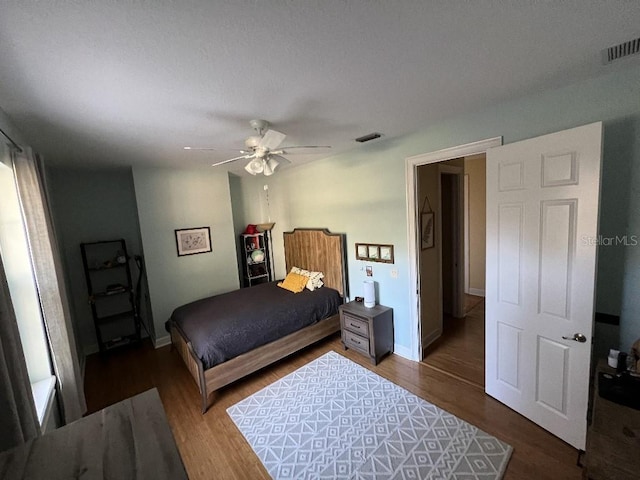 bedroom featuring hardwood / wood-style floors and ceiling fan