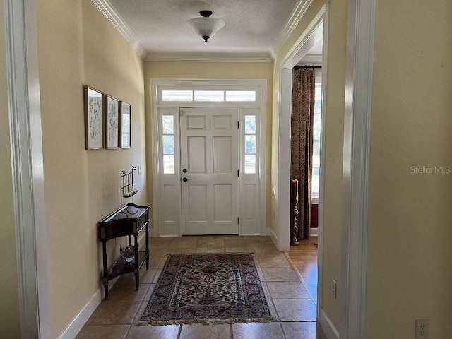 foyer entrance with a textured ceiling and ornamental molding