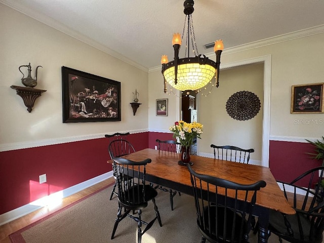 dining room featuring crown molding and hardwood / wood-style floors