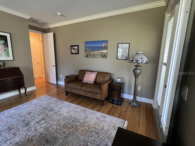 living room with wood-type flooring and ornamental molding