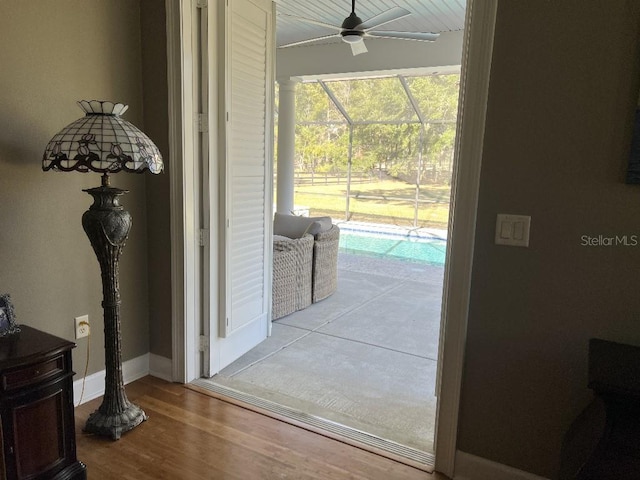 doorway to outside featuring ceiling fan and light wood-type flooring