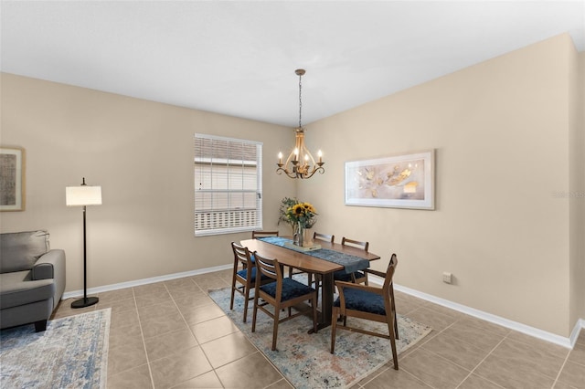 dining space featuring light tile patterned floors and a chandelier