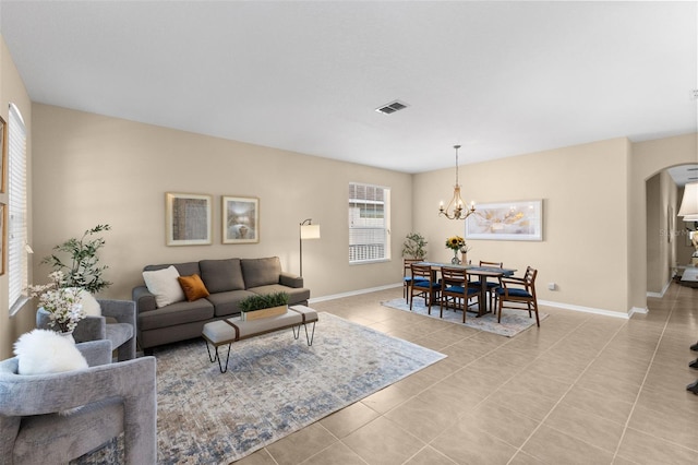 living room featuring light tile patterned flooring and a notable chandelier