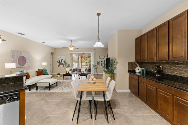 tiled dining space with ceiling fan