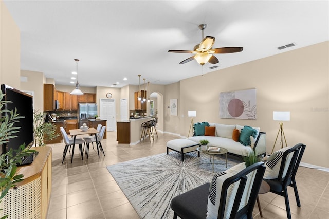 tiled living room with ceiling fan