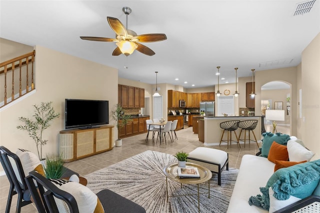 tiled living room with ceiling fan