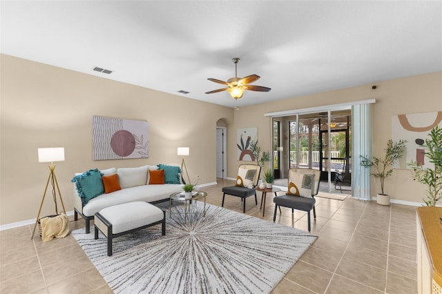 tiled living room with ceiling fan