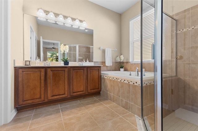 bathroom with plus walk in shower, vanity, and tile patterned flooring