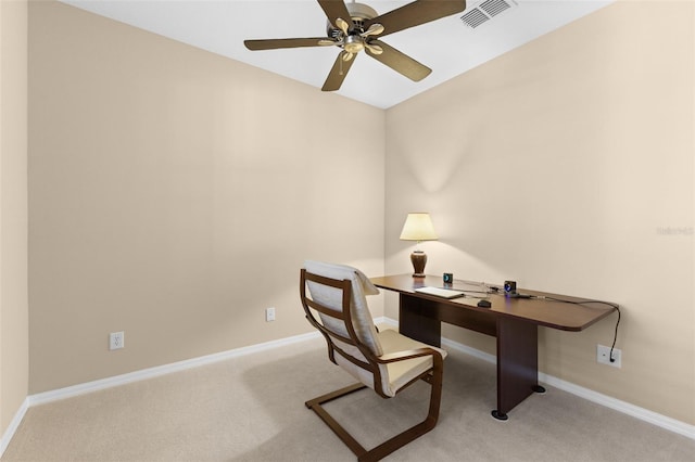 office space with ceiling fan and light carpet