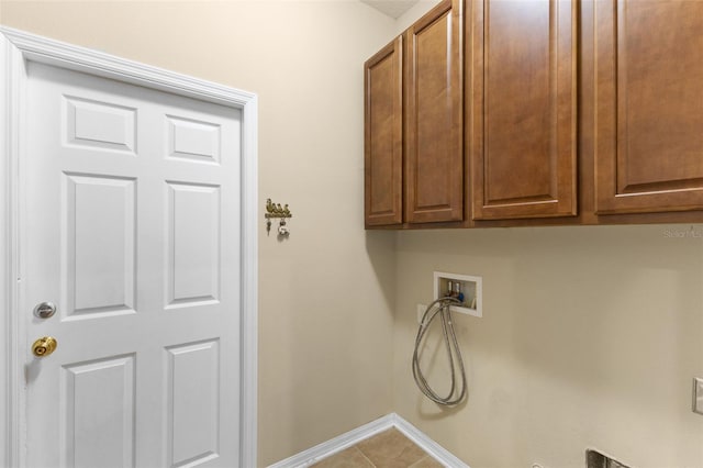 washroom featuring cabinets, hookup for a washing machine, and tile patterned floors