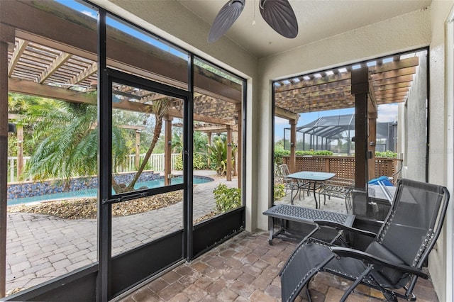 unfurnished sunroom featuring ceiling fan