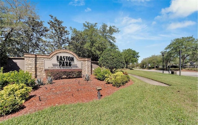 community / neighborhood sign with a lawn