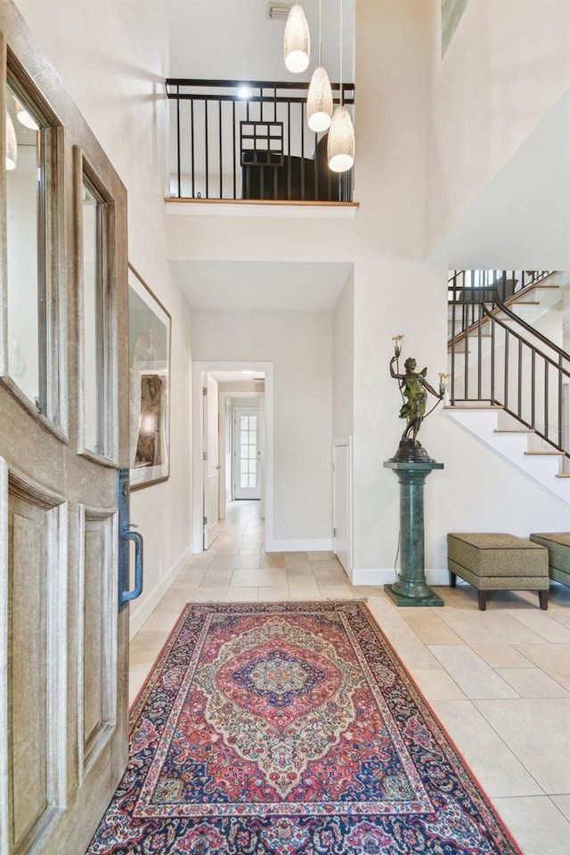 tiled foyer with a high ceiling